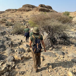 Volunteers walking towards large hill in Namibia